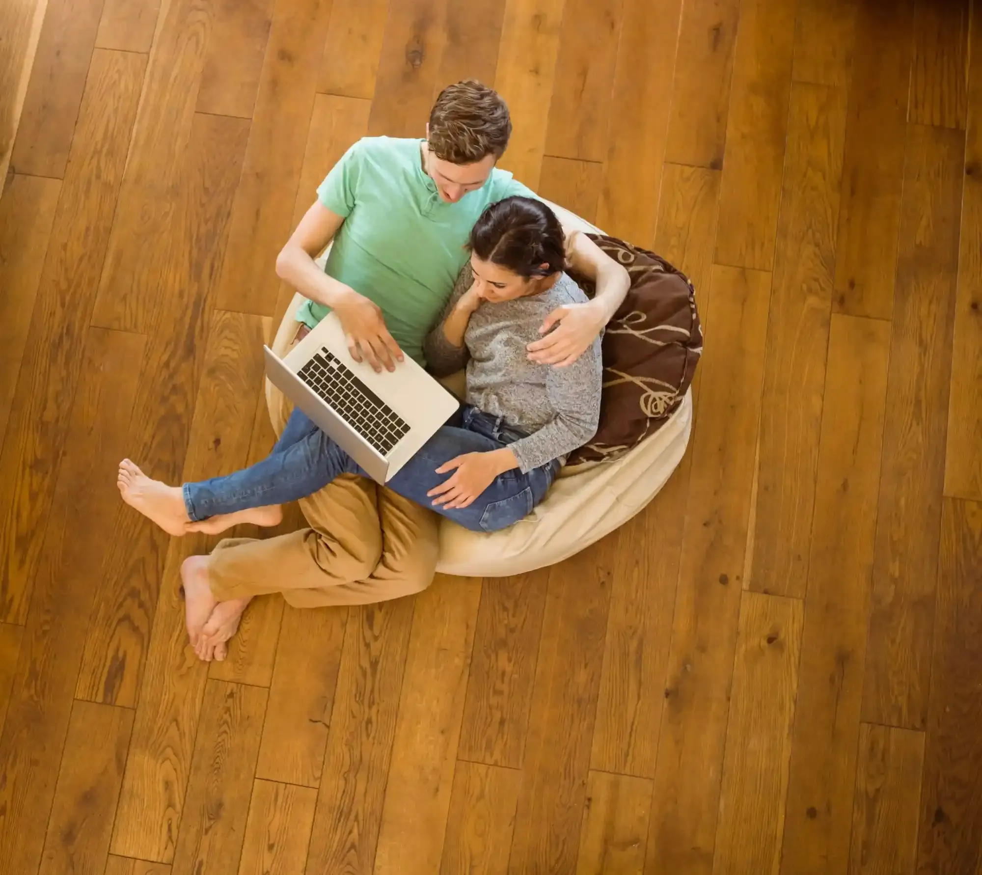 couple-sitting-on-wood-floor